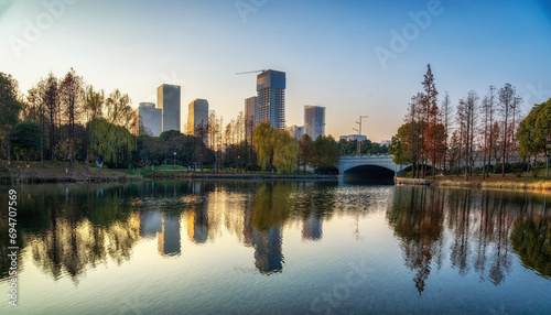 A modern city by the lake at sunset © evening_tao