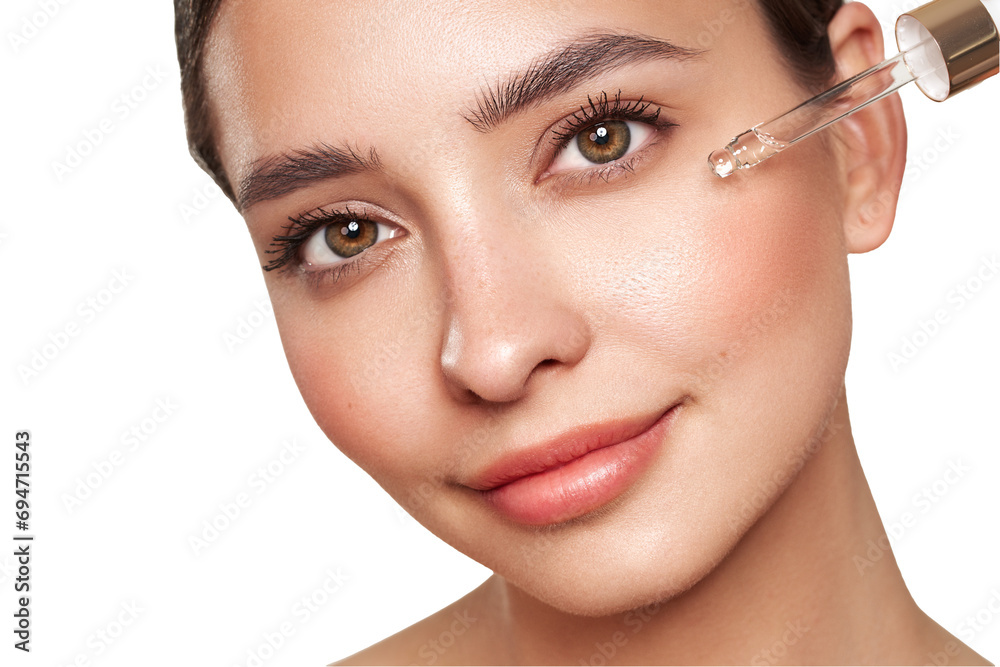 Young beautiful woman applying face serum with pipette. Cosmetic procedures for facial skin care Young beautiful woman applying face serum with pipette. Cosmetic procedures for facial skin care
