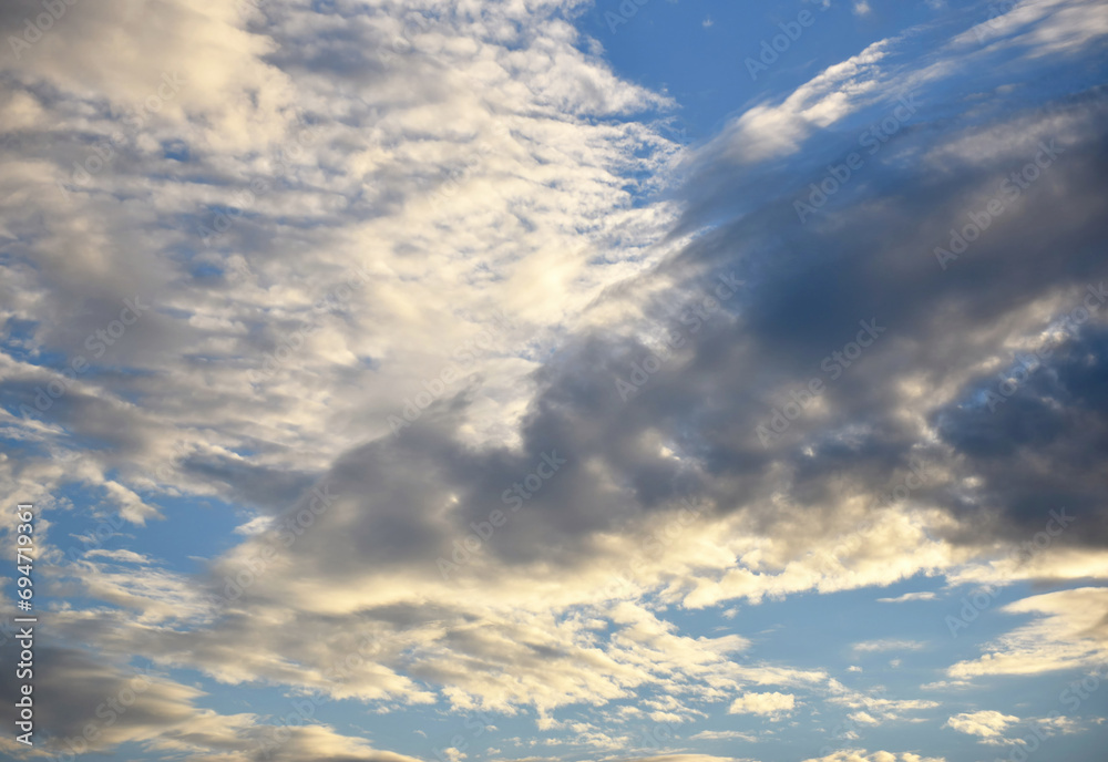Cloudscape, Colored Clouds at Sunset near the Ocean in a Blue Sky Cloudscape, Colored Clouds at Sunset near the Ocean in a Blue Sky