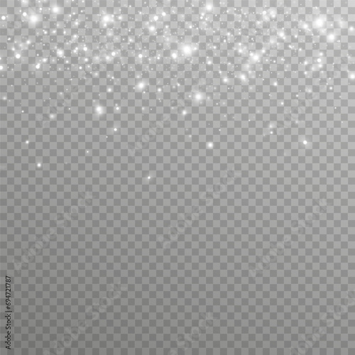 Particles of white magic dust. Shining light particles.Christmas glitter particles. Light effect on a transparent background 
