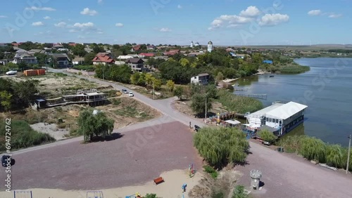Aerial drone shot panning from the right to the left over the Danube Delta, located near the Black Sea in Jurilovca, in Tulcea County, in Romania. photo