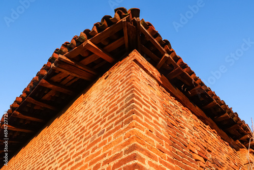 Ancient farmhouse ruin columns roof bricks uninhabited