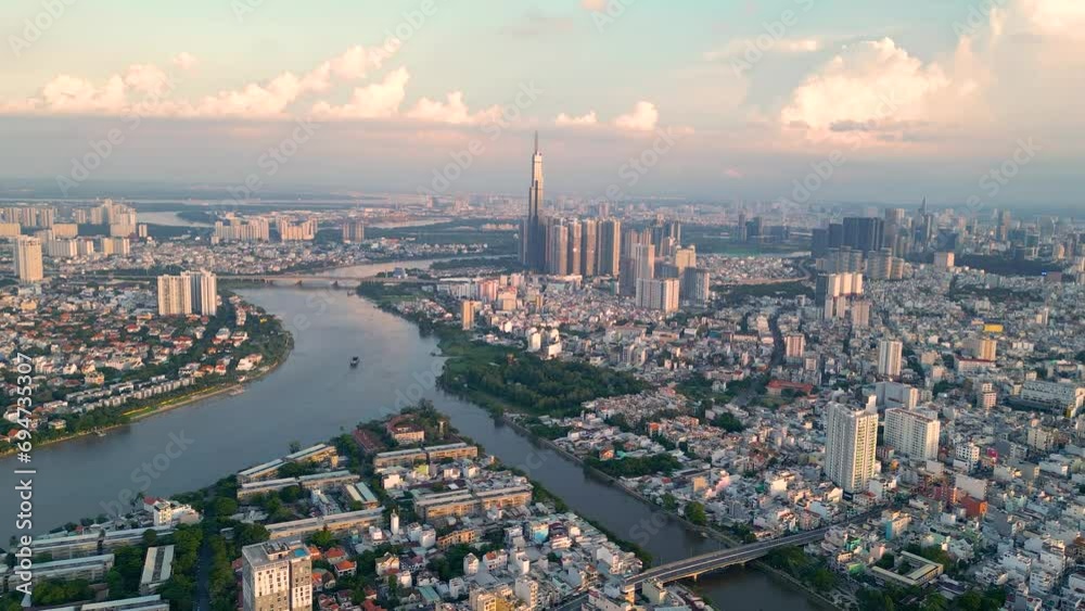 Panoramic view of Saigon, Vietnam from above at Ho Chi Minh City's central business district. Cityscape and many buildings, local houses, bridges, rivers