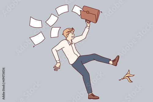 Falling man office employee slipped on banana peel and scattered documents from briefcase. Unfortunate guy slipped due to leftover food lying on ground and risks getting leg or head injury