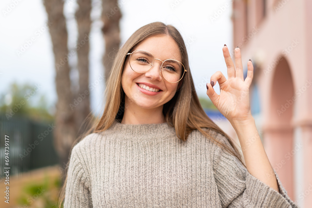 Young pretty blonde woman With glasses and doing OK sign Young pretty blonde woman With glasses and doing OK sign