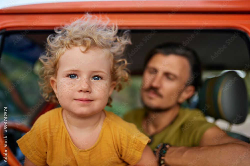 Innocent girl with father sitting in caravan on vacation Innocent girl with father sitting in caravan on vacation
