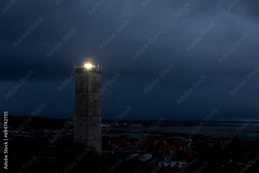 Lighthouse Brandaris on the Dutch island Terschelling by night under a cloudy sky