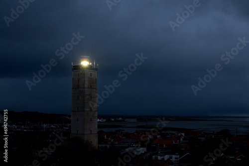 Lighthouse Brandaris on the Dutch island Terschelling by night under a cloudy sky