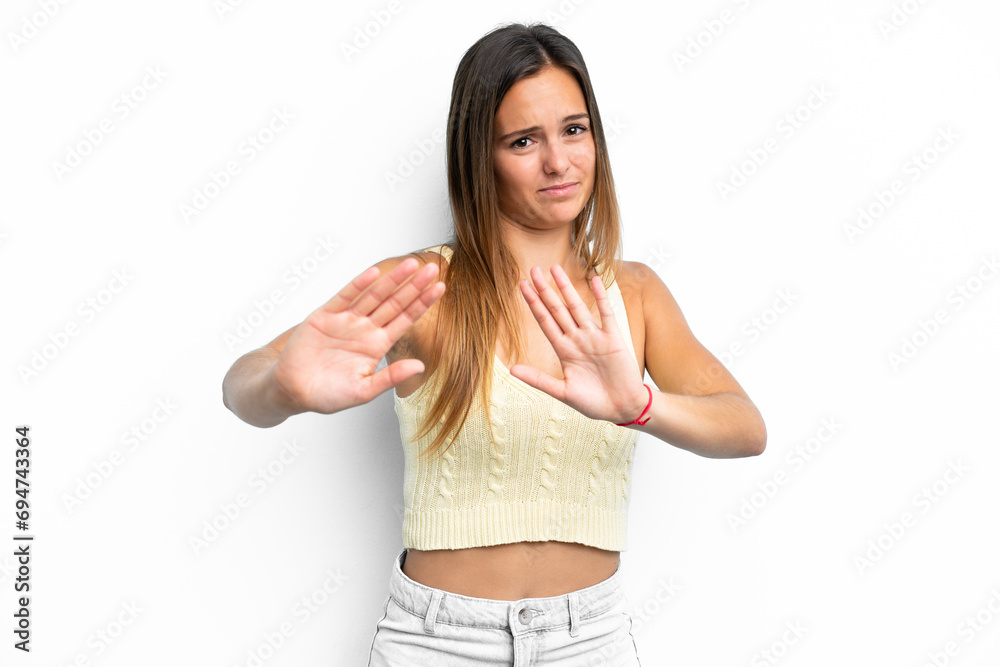 Young caucasian woman isolated on white background nervous stretching hands to the front