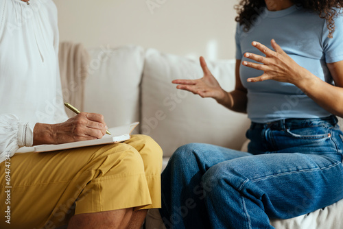 Patient with psychotherapist having consultation meeting at home photo