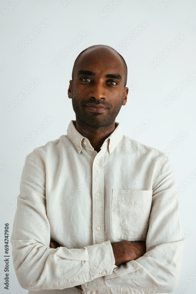 Man with arms crossed against white background