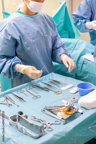 Nurse holding surgical equipment in emergency room