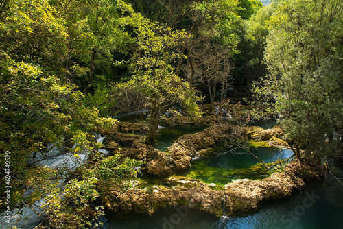 Travertine pools in the River Una at the Small Waterfalls at Martin Brod in Una-Sana Canton, Federation of Bosnia and Herzegovina. Located within the Una National Park. Early September