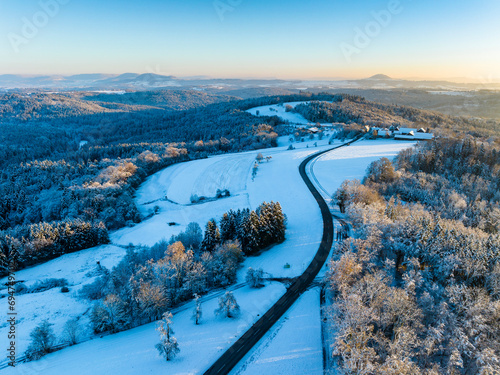 Germany, Baden-Wurttemberg, Aerial view of road in snow-coveredRemstal valley photo