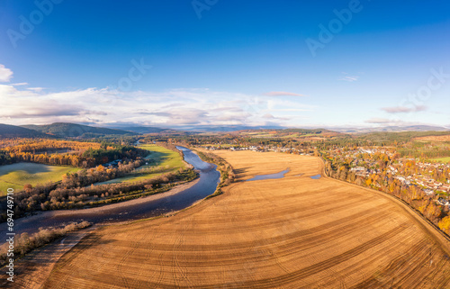 UK, Scotland, Aboyne, Aerial view of river Dee and vast field in autumn