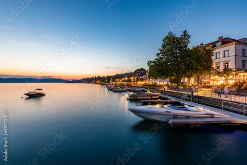 Germany, Baden-Wurttemberg, Uberlingen, Long exposure of harbor on lake Bodensee at dusk photo