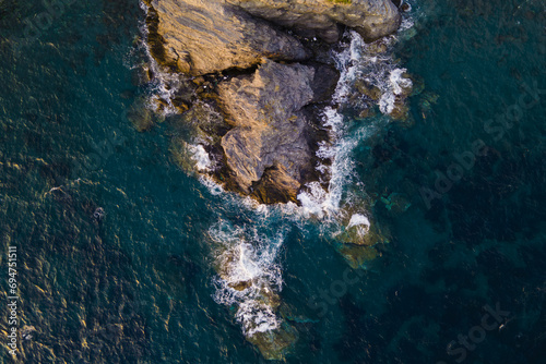 Rocky coastline Aegean sea with rocky reefs, aerial top down shot
