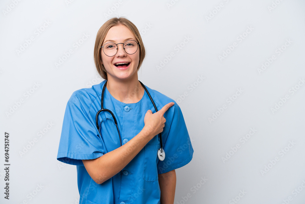 Young nurse doctor woman isolated on white background surprised and pointing side Young nurse doctor woman isolated on white background surprised and pointing side