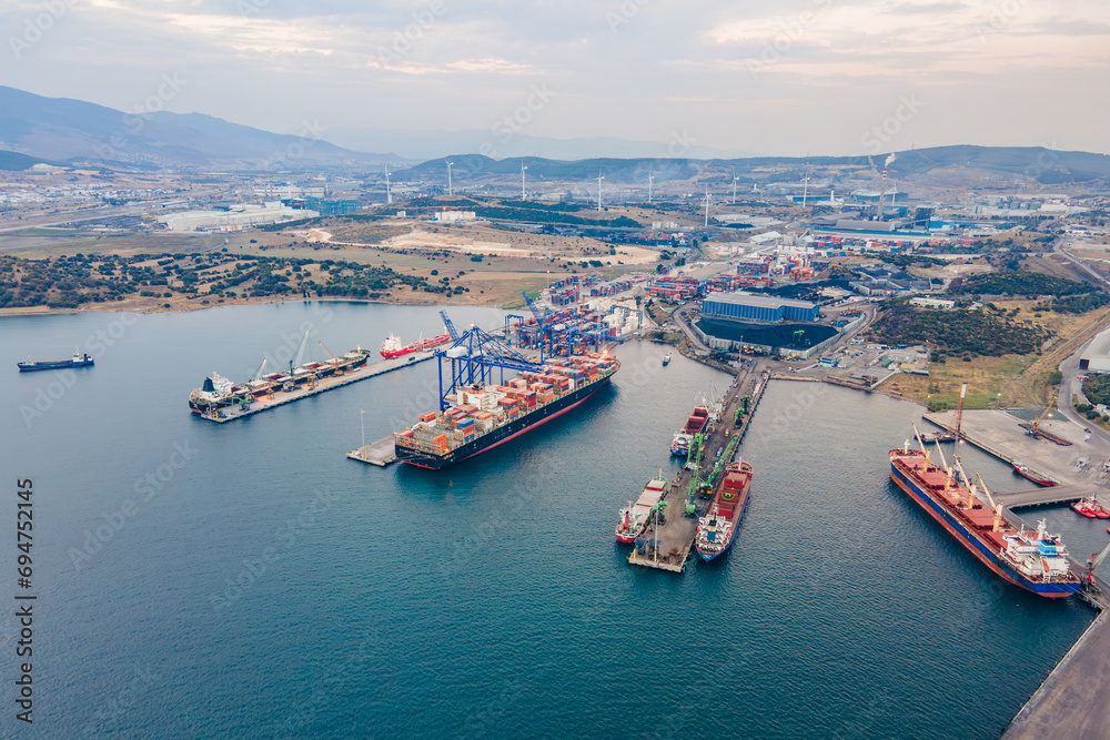 Aerial wide shot of Industrial port with container terminal with loading and unloading cargo ships