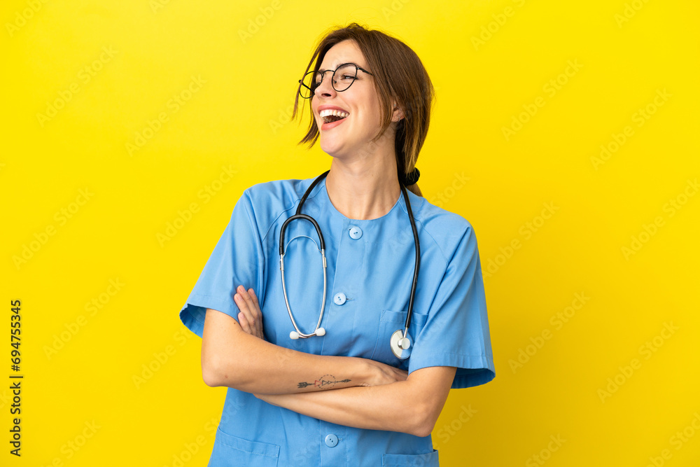 Surgeon doctor woman isolated on yellow background happy and smiling Surgeon doctor woman isolated on yellow background happy and smiling