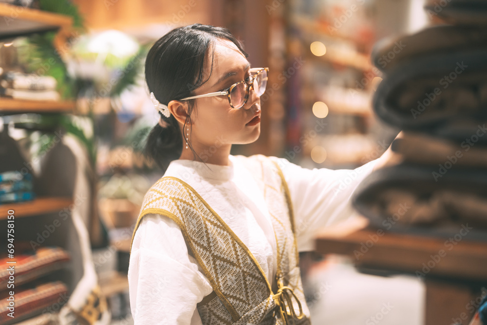 Fototapeta premium Asian stylish woman in vintage cloth shop purchase new fashion