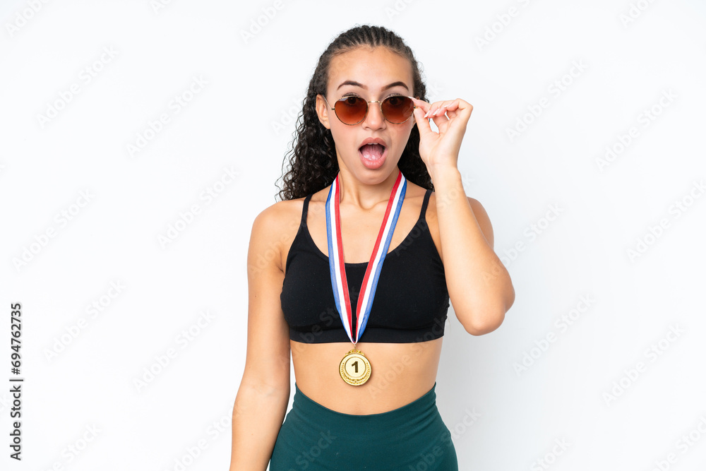 Young sport woman with medals isolated on white background with glasses and surprised Young sport woman with medals isolated on white background with glasses and surprised