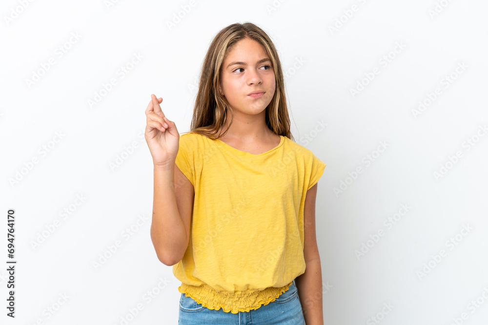 Little caucasian girl isolated on white background with fingers crossing and wishing the best Little caucasian girl isolated on white background with fingers crossing and wishing the best