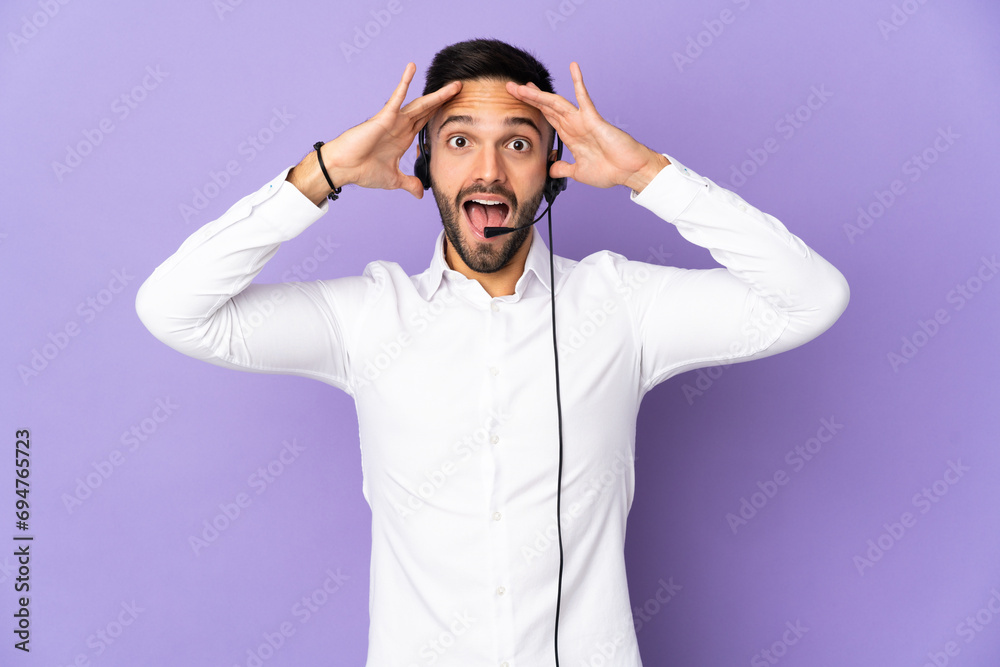 Telemarketer man working with a headset isolated on purple background with surprise expression Telemarketer man working with a headset isolated on purple background with surprise expression