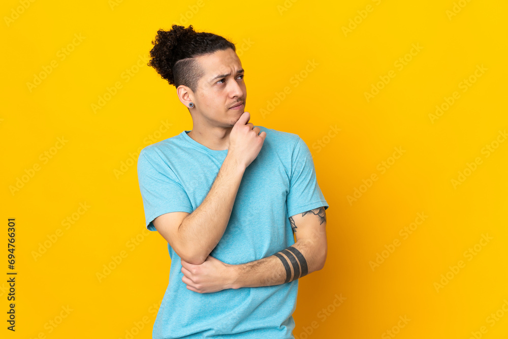 Caucasian man over isolated background and looking up Caucasian man over isolated background and looking up