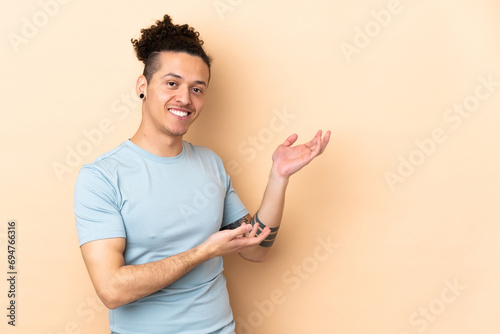 Caucasian man over isolated background extending hands to the side for inviting to come