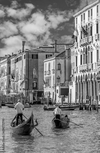 Two gondoliers cross the famous Grand Canal in Venice, Italy, in black and white © Marco Taliani