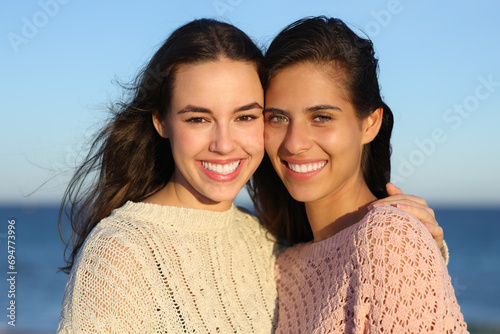 Two happy women smiling with perfect smiles at camera photo