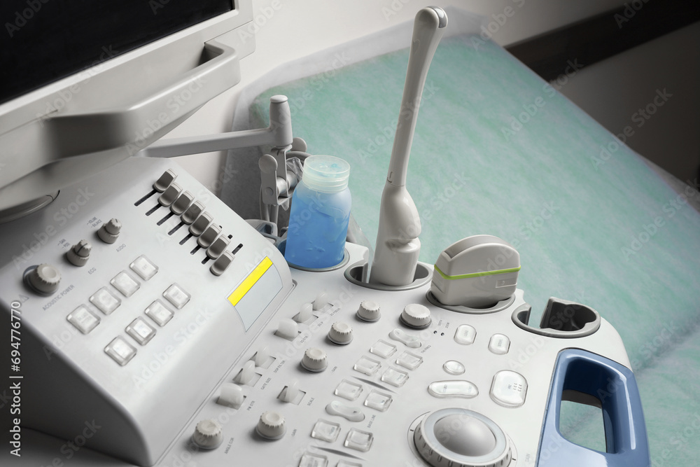 Ultrasound control panel and examination table in hospital, closeup Ultrasound control panel and examination table in hospital, closeup