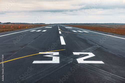 Obraz na płótnie Airport runway with markings on the asphalt. The concept of travel and tourism w salonie