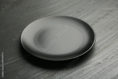 Beautiful ceramic plate on black table, closeup