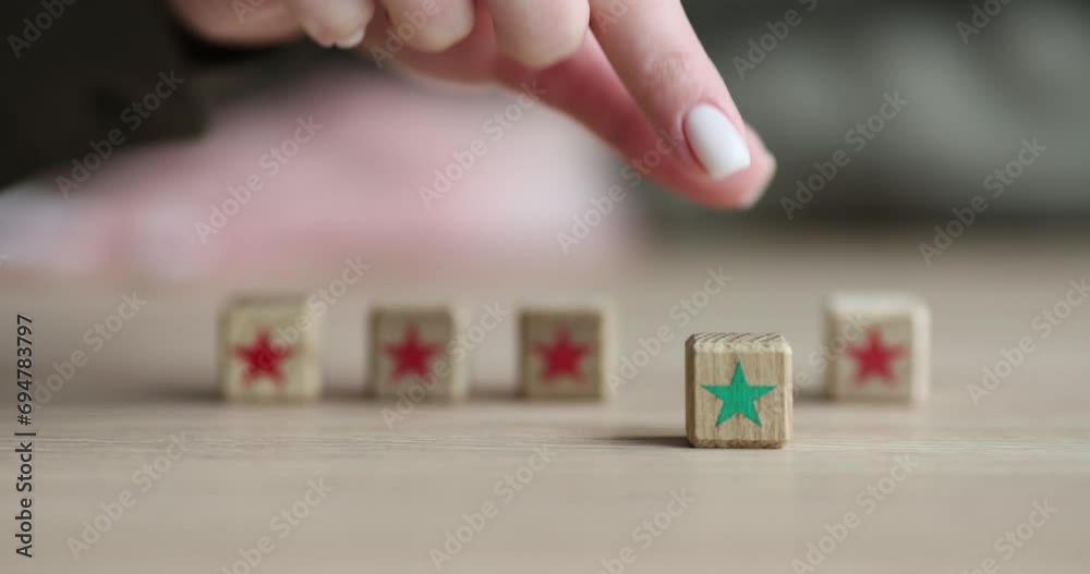 Five stars on wooden cubes on the table, close-up. Assessment of the level of professional training, concept Five stars on wooden cubes on the table, close-up. Assessment of the level of professional training, concept
