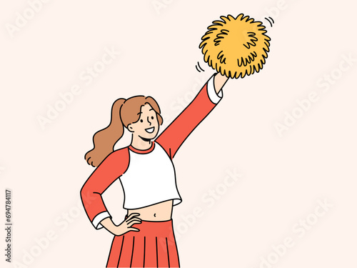 Woman cheerleader raises hand with pumpon up supporting college soccer team. Cheerleader teenager cheers for university at athletic tournament and shouts to motivate football players