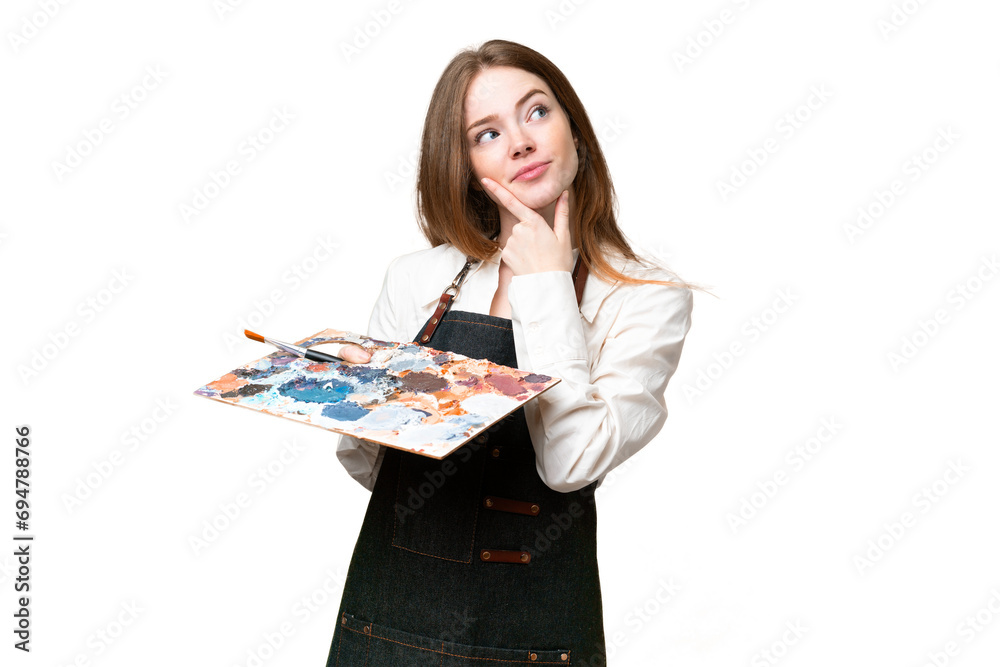 Young artist woman holding a palette over isolated chroma key background having doubts Young artist woman holding a palette over isolated chroma key background having doubts