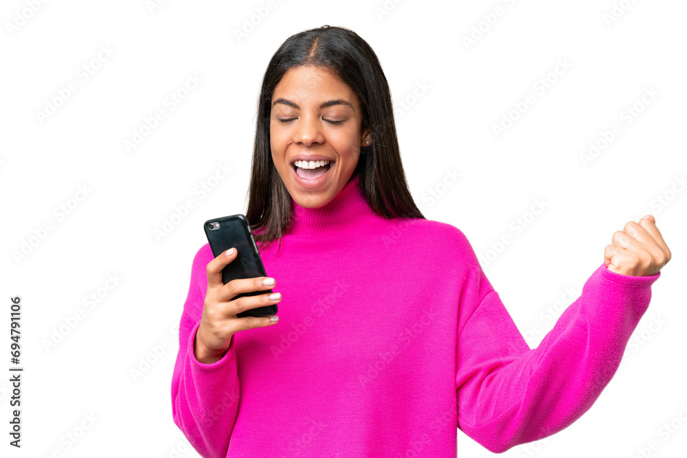 Young African American woman over isolated background using mobile phone and doing victory gesture Young African American woman over isolated background using mobile phone and doing victory gesture