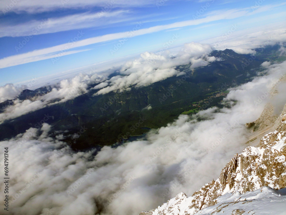 Obraz premium View from the mountain to the valley and the clouds above it. A picturesque panorama of wild nature