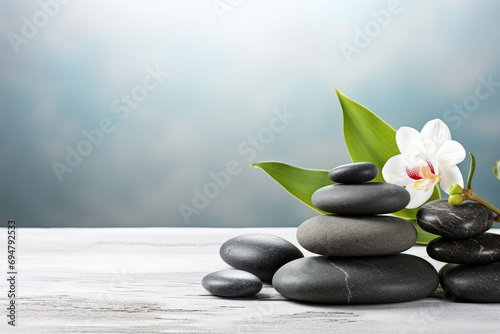 Candles, flowers and spa stones on nature background