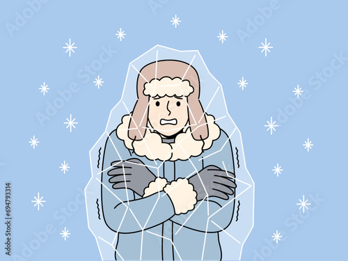 Frozen man stands inside block of ice and chatters teeth, suffering due to sudden climate change. Frozen guy in hat and winter jacket needs warm room and hot drink to avoid illness