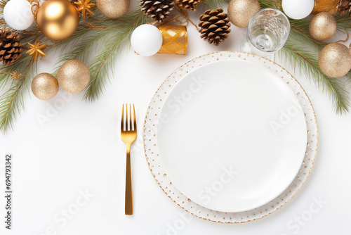Stylish table setting, fir branches, balls with white plate and cutlery