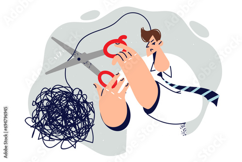 Man with psychological problems cuts off tangled cord thought symbolizing stress due to toxic work