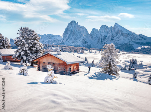 Tourist takes picture on smartphone of Alpe di Siusi village with Plattkofel peak on background. Cold morning view of Dolomite Alps. Snowy outdoor scene of Ityaly, Europe. Traveling concept background © Andrew Mayovskyy