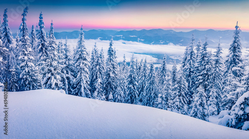Fantastic winter scenery. Snowy morning view of the mountain hill. Amazing winter sunrise in Carpathian mountains. Beauty of nature concept background. © Andrew Mayovskyy