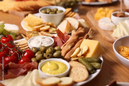 Assorted appetizers served on wooden table, closeup