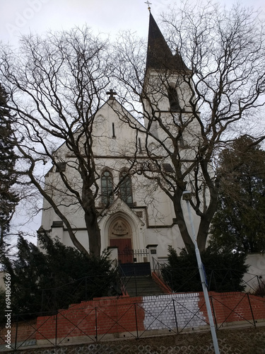 Church on a hill behind the trees