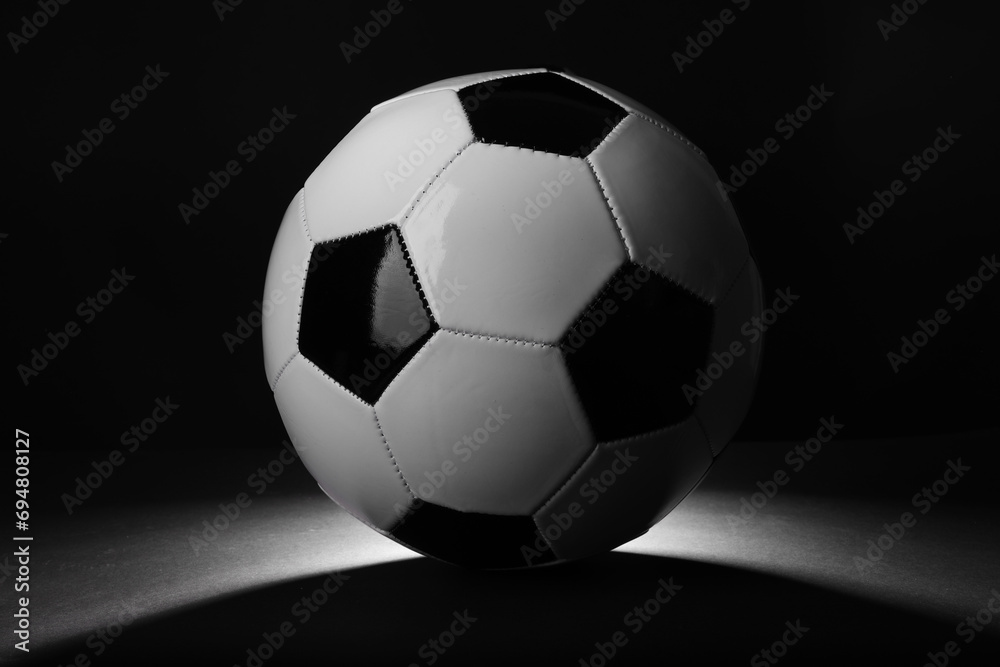 One soccer ball in darkness. Sports equipment