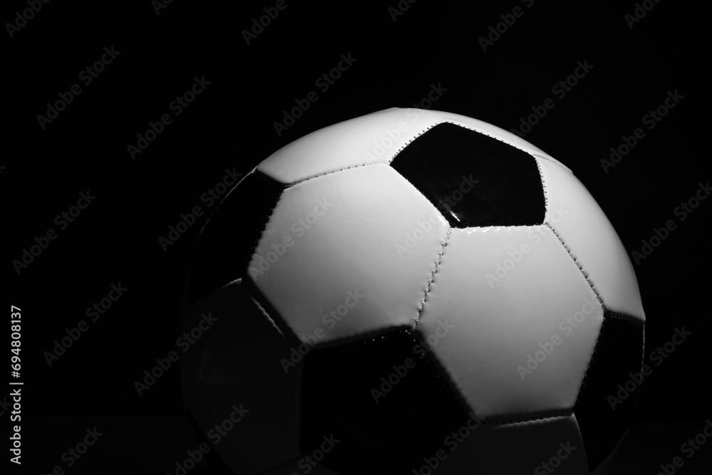 One soccer ball on black background, closeup. Sports equipment